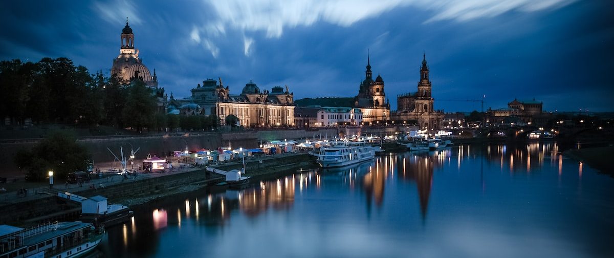 body of water near city buildings during night time