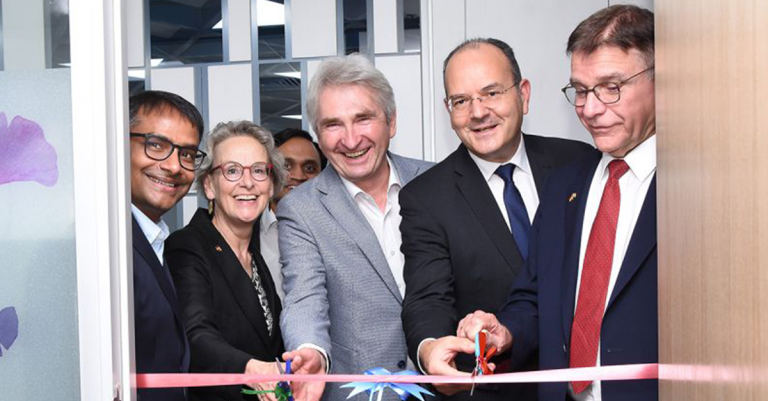 Meschen, die ein Band zerschneiden.